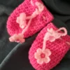Hot pink crochet baby mittens with flower tie cord