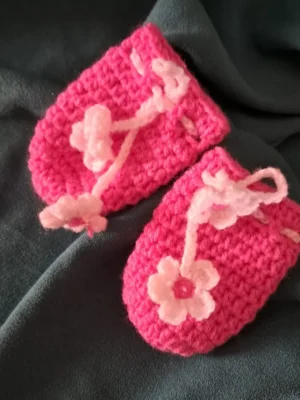 Hot pink crochet baby mittens with flower tie cord
