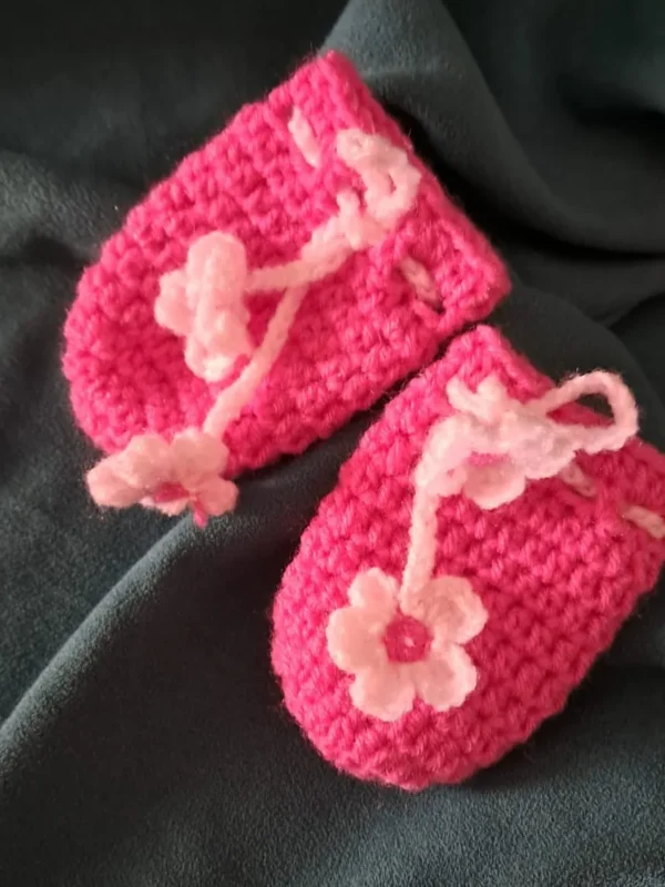 Hot pink crochet baby mittens with flower tie cord