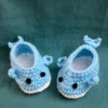 Blue Whale Baby Booties, view 3 Light blue crochet whale baby booties