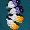 Crochet flower cluster hair clips for girls in purple and yellow-orange