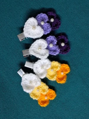 Crochet flower cluster hair clips for girls in purple and yellow-orange