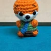 Little Fox Amigurumi, view 1 Crochet orange fox amigurumi in green shirt and blue tie
