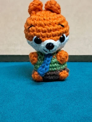 Little Fox Amigurumi, view 1 Crochet orange fox amigurumi in green shirt and blue tie