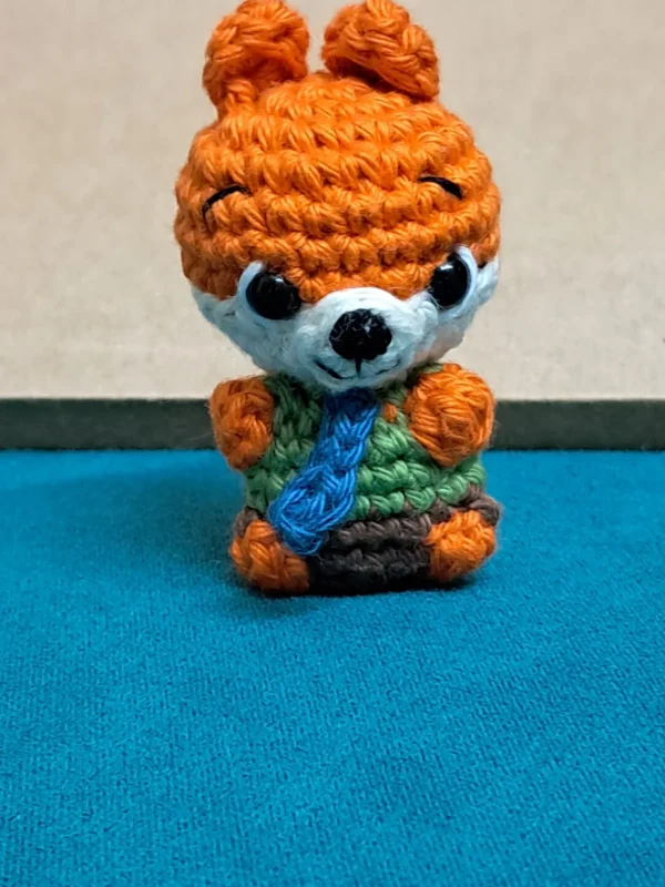 Little Fox Amigurumi, view 1 Crochet orange fox amigurumi in green shirt and blue tie