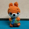 Little Fox Amigurumi, view 2 Crochet orange fox amigurumi in green shirt and blue tie