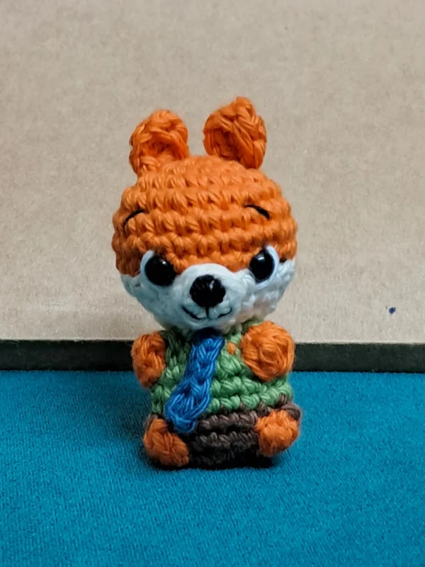 Little Fox Amigurumi, view 2 Crochet orange fox amigurumi in green shirt and blue tie