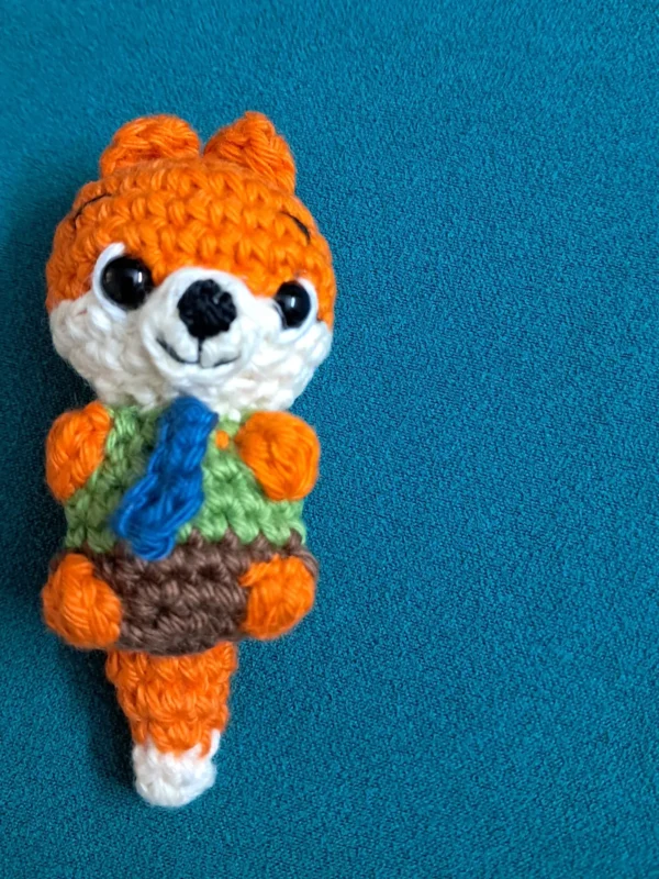 Little Fox Amigurumi, view 4 Crochet orange fox amigurumi in green shirt and blue tie