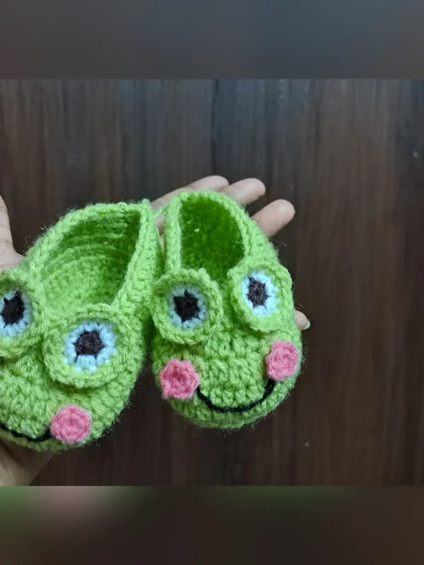 Little Frog Baby Booties, view 2 Green crochet frog baby booties with smiling face