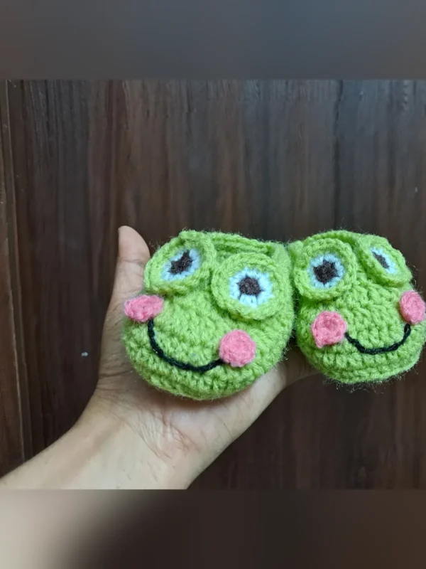 Little Frog Baby Booties, view 3 Green crochet frog baby booties with smiling face