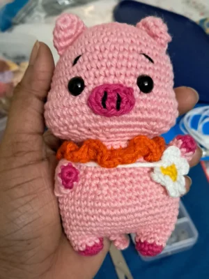 Crochet pink piggy amigurumi in pink overalls