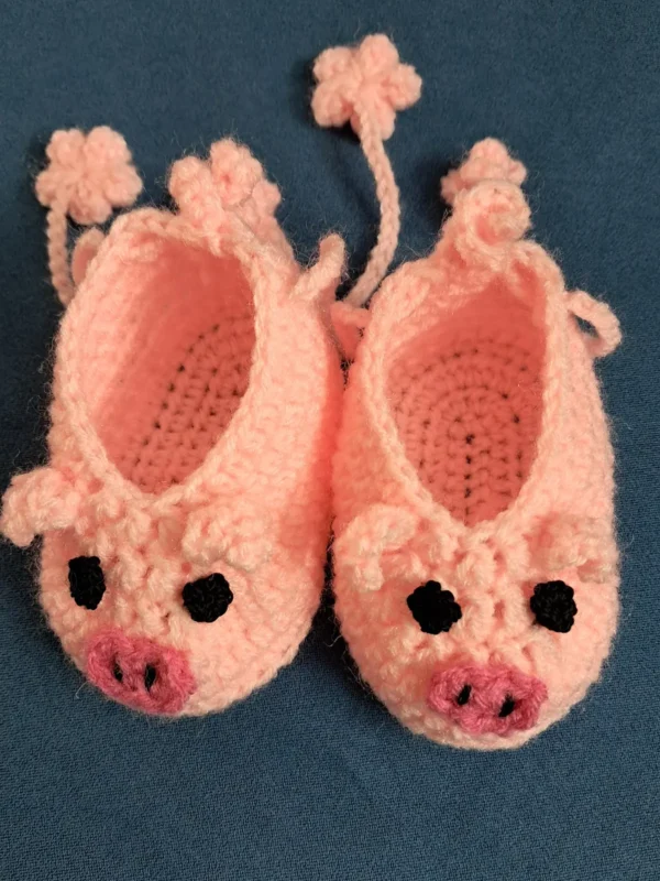 Pink Piggy Baby Booties, view 1 Peach pink crochet piggy baby booties with flower ties