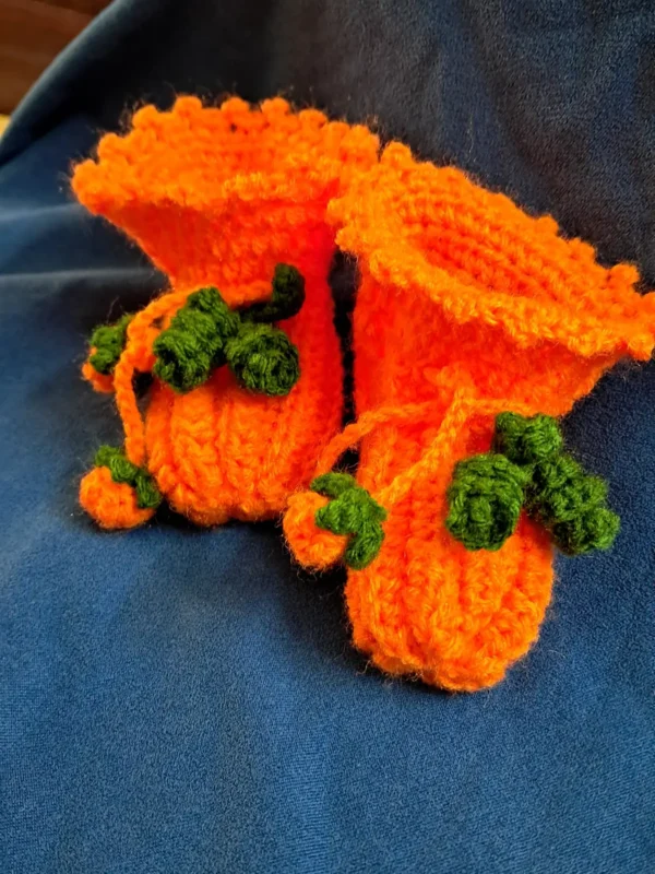 Pumpkin Baby Booties, view 1 Orange crochet pumpkin baby booties with green vine ties