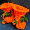 Pumpkin Baby Booties, view 2 Orange crochet pumpkin baby booties with green vine ties