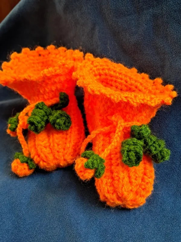 Pumpkin Baby Booties, view 2 Orange crochet pumpkin baby booties with green vine ties