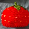 Red crochet strawberry baby cap with green stem