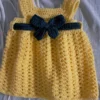 Yellow crochet baby girl pinafore dress with dark green bow